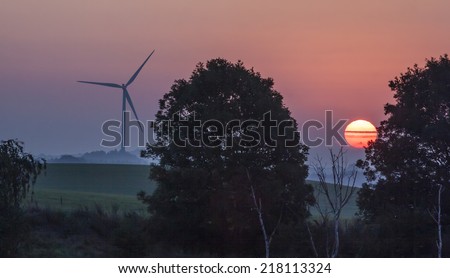 Two components for a clean future, sun and wind. Here in sunrise in south Sweden
