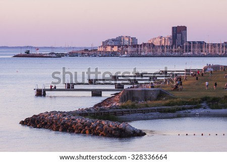 Part of Malmoe Sweden with the beach and the jetties when sunset in May