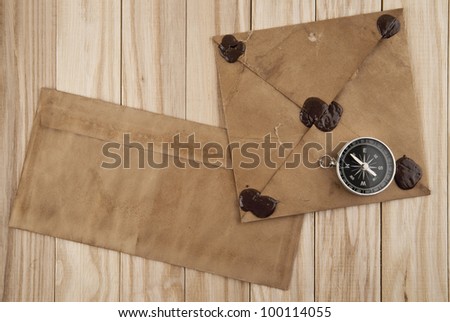 old letters and compass on a wooden background