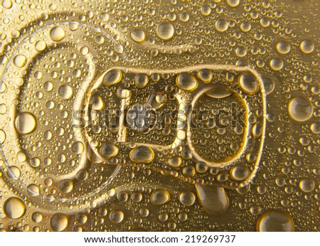 can of beer in drops of water as a background