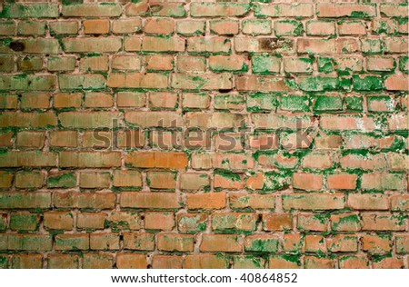 green brick wall in bad repair