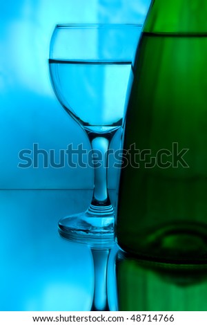 still life by tall wine glass and bottle of wine for your illustrations
