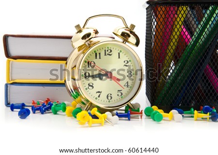 books, clock and pencils on a white background