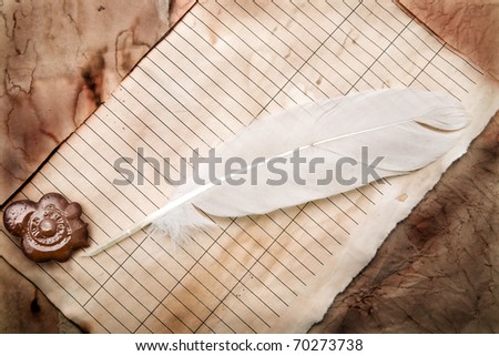 old paper with a feather as a background