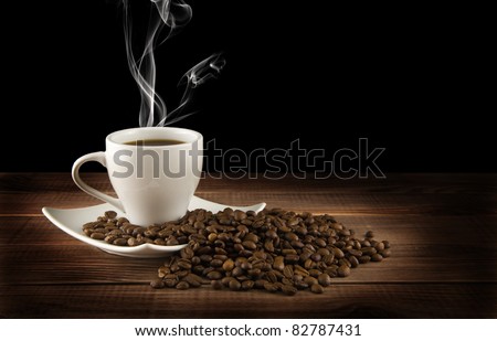 cup of coffee with grains on a black background