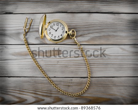 gold clock on a dark wooden background