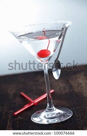 Dry Martini with a cherry on a aged background