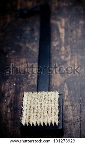 Black bath brush on wooden rustic background