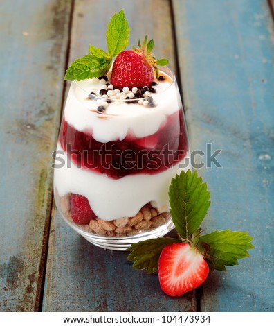 Healthy strawberry dessert with creamy yoghurt layered with pure and fresh fruit in a glass