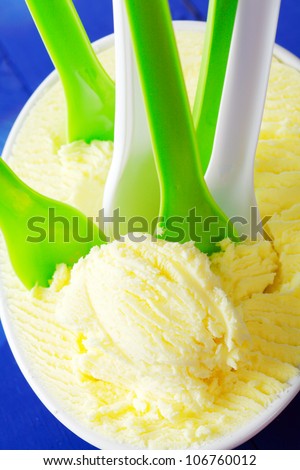 Many Ice Cream Spoons in vanilla icecream. Summer party with frozen ice-cream.