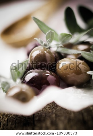 Delicious fresh black olives and leaves with shallow depth of field and copyspace