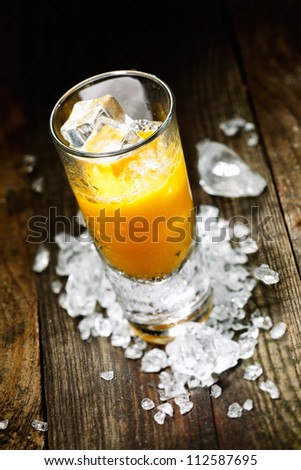 Hard Liquor Orange Juice Shooter on a countertop with crushed ice and alcohol for drink concepts look at my portofolio