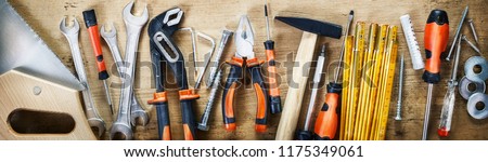 Panorama banner of assorted hand tools on wood for renovations, DIY, building and construction or woodworking