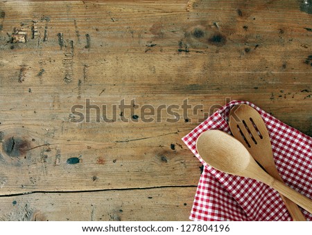 Serving Spoons On Checkered Cloth Lying On Wooden Surface