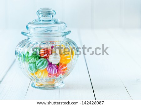 Photograph of a beautiful jar full of assorted colorful candies, perfect for gift purpose.