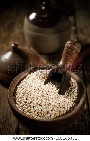 High angle close up view showing the texture of a container of dried quinoa seeds, a high-protein gluten-free vegetable originating in South America and a staple ingredient of rural nutrition