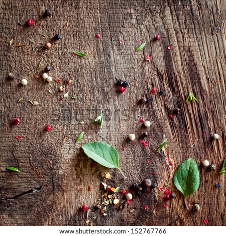 Background Of Peppercorns And Basil Scattered On An Old Weathered Wooden Surface After Preparing And Seasoning A Meal