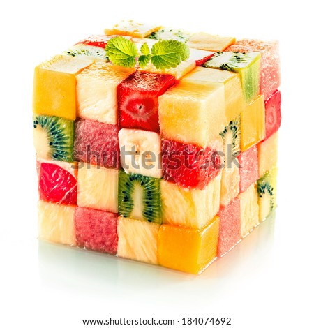 Fruit cube formed from small squares of assorted tropical fruit in a colorful arrangement including kiwifruit, strawberry, orange, banana and pineapple on a white background