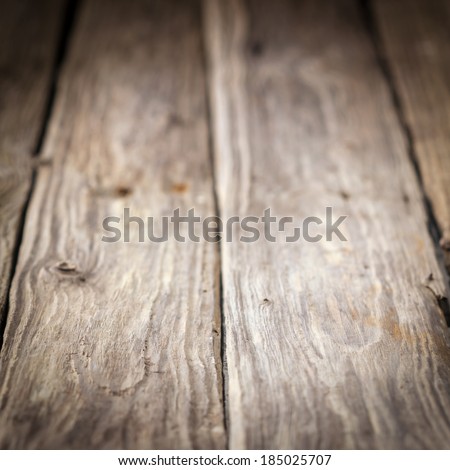 Background of old weathered wooden boards with a diminishing perspective and shallow dof in square format