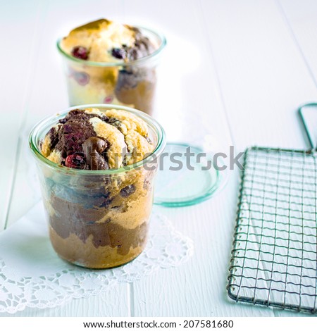 Freshly baked serving of marble cake with fresh berries served in an individual glass for a tasty dessert