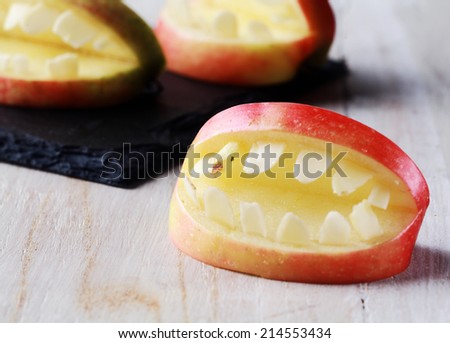 Creative Halloween apple with teeth in a cutout shape with an open mouth for a healthy scary trick-or-treat favor
