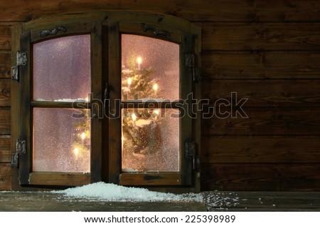 Small Amount of Snow at Vintage Wooden Window Pane with Christmas Lights Inside the House.