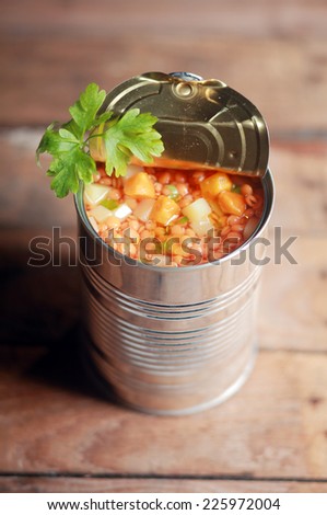 High angle view of an opened can of lentil and mixed vegetable soup garnished with fresh parsley for a delicious winter appetizer