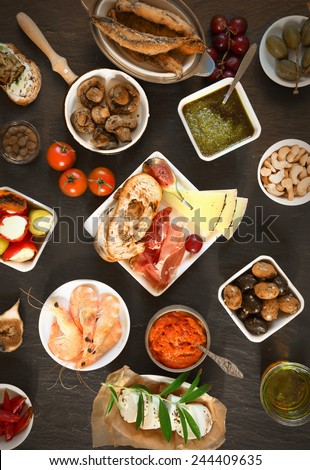 Food Concept - Wide Variety Appetizing Tapas on Top of Brown Wooden Table