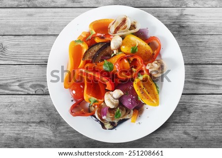 Close up Aerial Shot of Appetizing Healthy Recipe with Mushrooms and Spices on White Plate. Placed on Wooden Table.