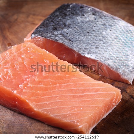 Close up Front and Back Slice of Fresh Fish Meat on Top of Wooden Chopping Board