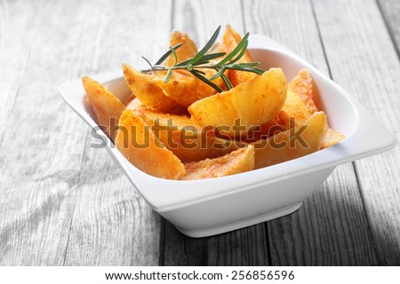 Close up Tasty Fried Potato Snacks on White Bowl on Top of Wooden Table
