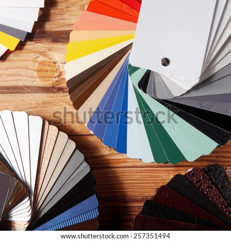 Close up Color Palette Guide Fans for Home Designs on Top of Wooden Table