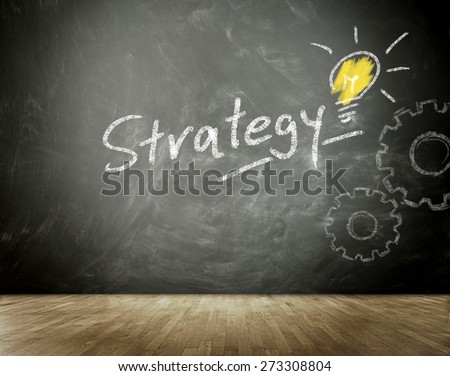 Conceptual Strategy Message Written on Black Chalkboard with Light Bulb and Gears Drawings.