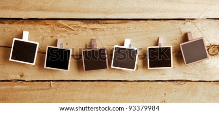 Six Squary  photo frames in a row on wooden background