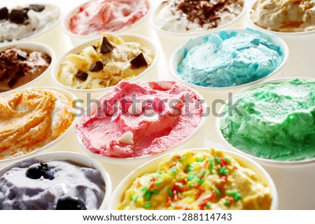 Display of tasty summer ice cream in different flavors and colors served in individual tubs viewed obliquely for advertising for a parlour or ice cream shop
