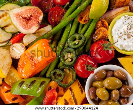 Extreme Close Up of Bounty of Colorful Grilled Vegetables and Dish of Olives