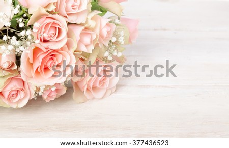 Delicate bouquet of fresh pink roses on a textured white wood background with copy space for your Valentines, Mothers Day, anniversary or birthday wishes