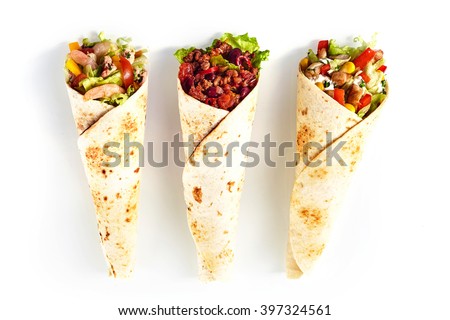 High Angle Still Life of Trio of Tex Mex Fajita Wraps Wrapped in Grilled Flour Tortillas and Filled with Variety of Fillings Such as Chicken, Chili and Shrimp and Fresh Vegetables on White Background