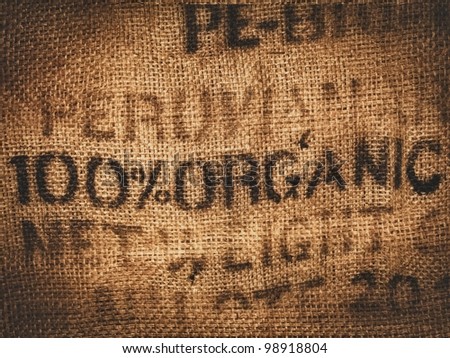 Background of a hessian coffee bag stamped and certified one hundred percent organic