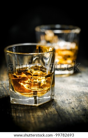 Whisky or Whiskey, vintage style, on a wooden plate