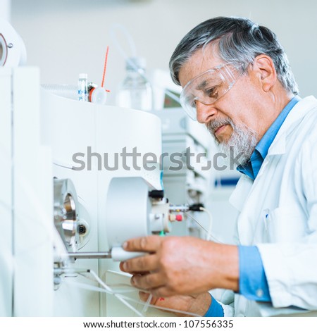 Senior male researcher carrying out scientific research in a lab (shallow DOF; color toned image)