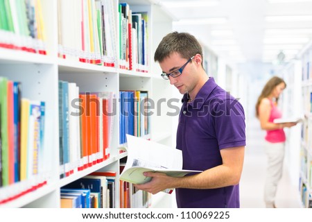 Handsome college student in library (shallow DOF; color toned image)