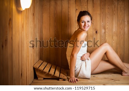 Young woman relaxing in a sauna