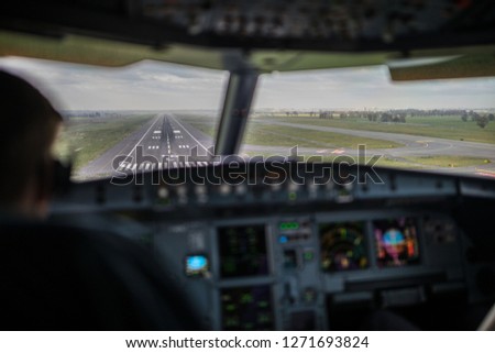 Pilot\'s view from a commercial airliner airplane flight cockpit during approach/landing