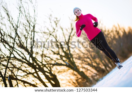 Young woman running outdoors on a cold winter day