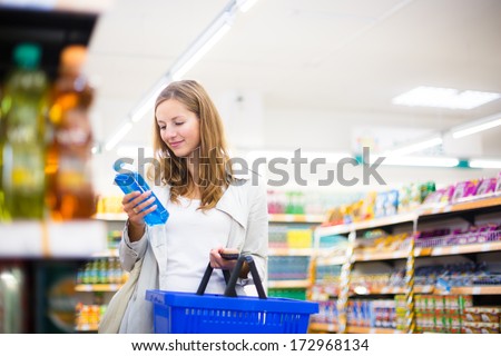 Beautiful Young Woman Shopping In A Grocery Store/Supermarket (Color Toned Image)