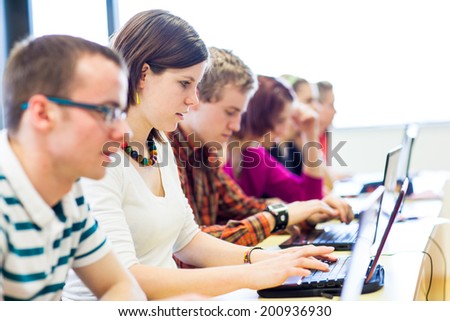 Group of college/university students in in a classroom during class (shallow DOF, color toned image)