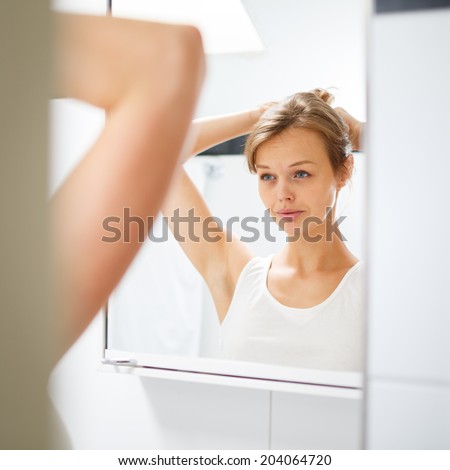 Pretty, young woman  in front of her bathroom during her morning routine (shallow DOF)