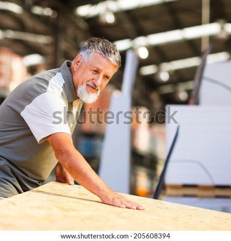 Man choosing and buying construction wood in a  DIY store for his DIY home re-modeling project