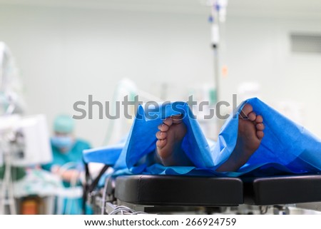 Feet of a patient ready  for a surgery in a surgery room (color toned image; shallow DOF)